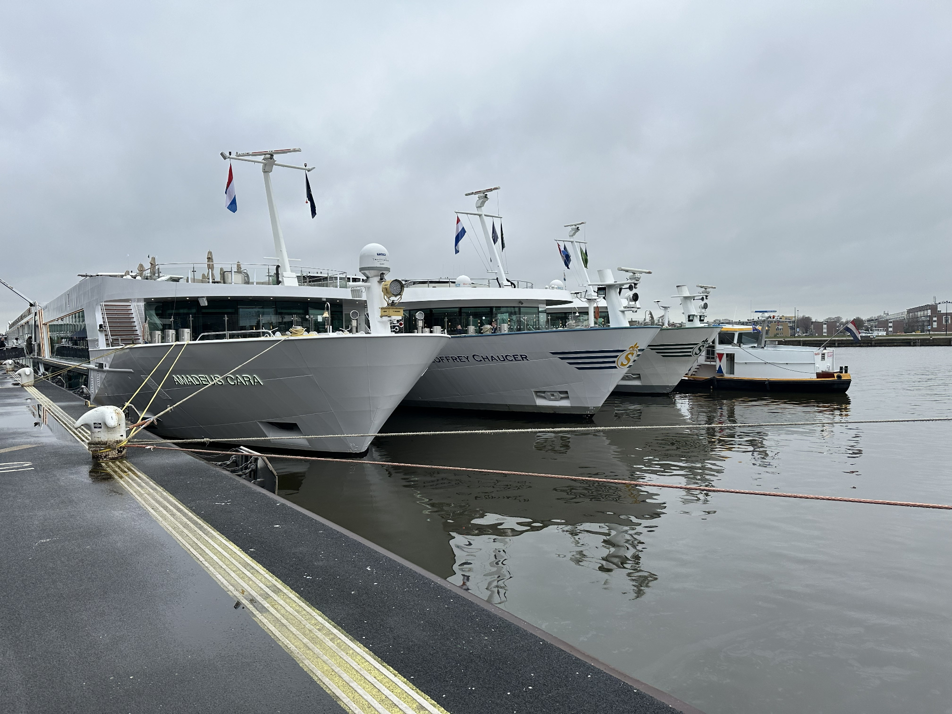 Luxury river cruise ships Amadeus Cara and Geoffrey Chaucer docked side by side in Amsterdam, illustrating how to choose the right river cruise line.
