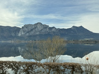 Alpine peaks reflected in still water on a clear winter day ashore during the December 2024 Danube Christmas Markets river cruise
