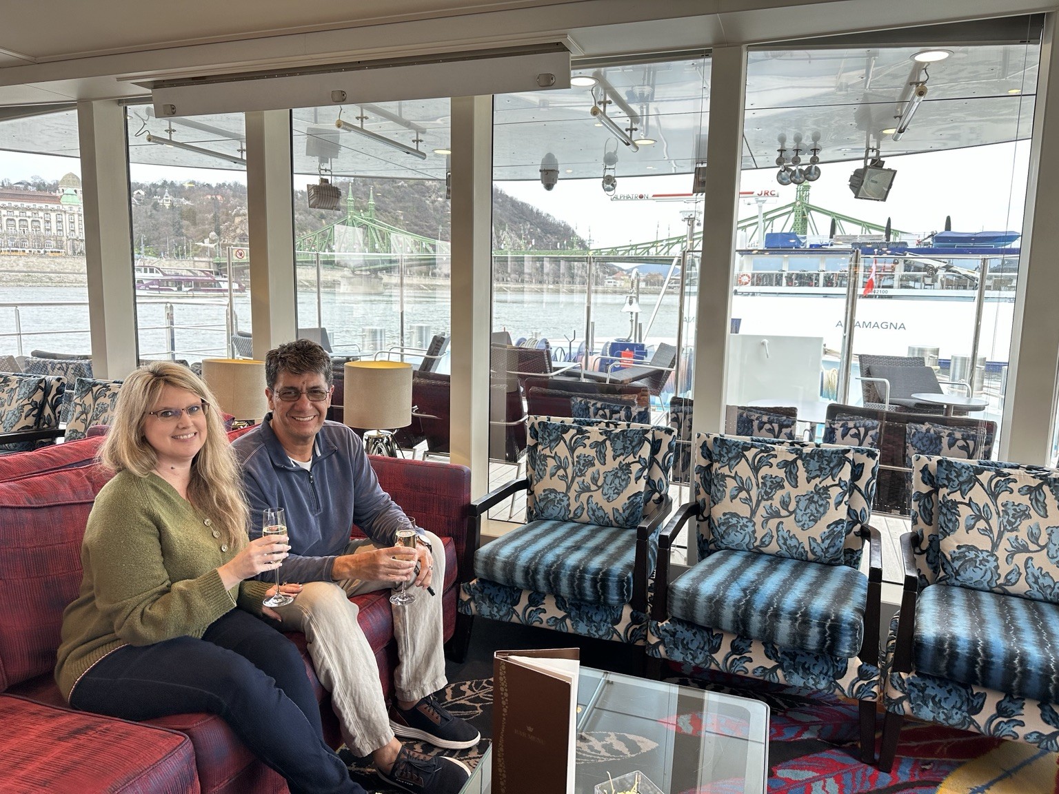 Melissa Yetter aboard a European river cruise ship lounge overlooking the Danube