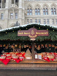 Gingerbread and Lebkuchen stall decorated with garland and red hearts at the Vienna Christkindlmarkt in front of the Rathaus