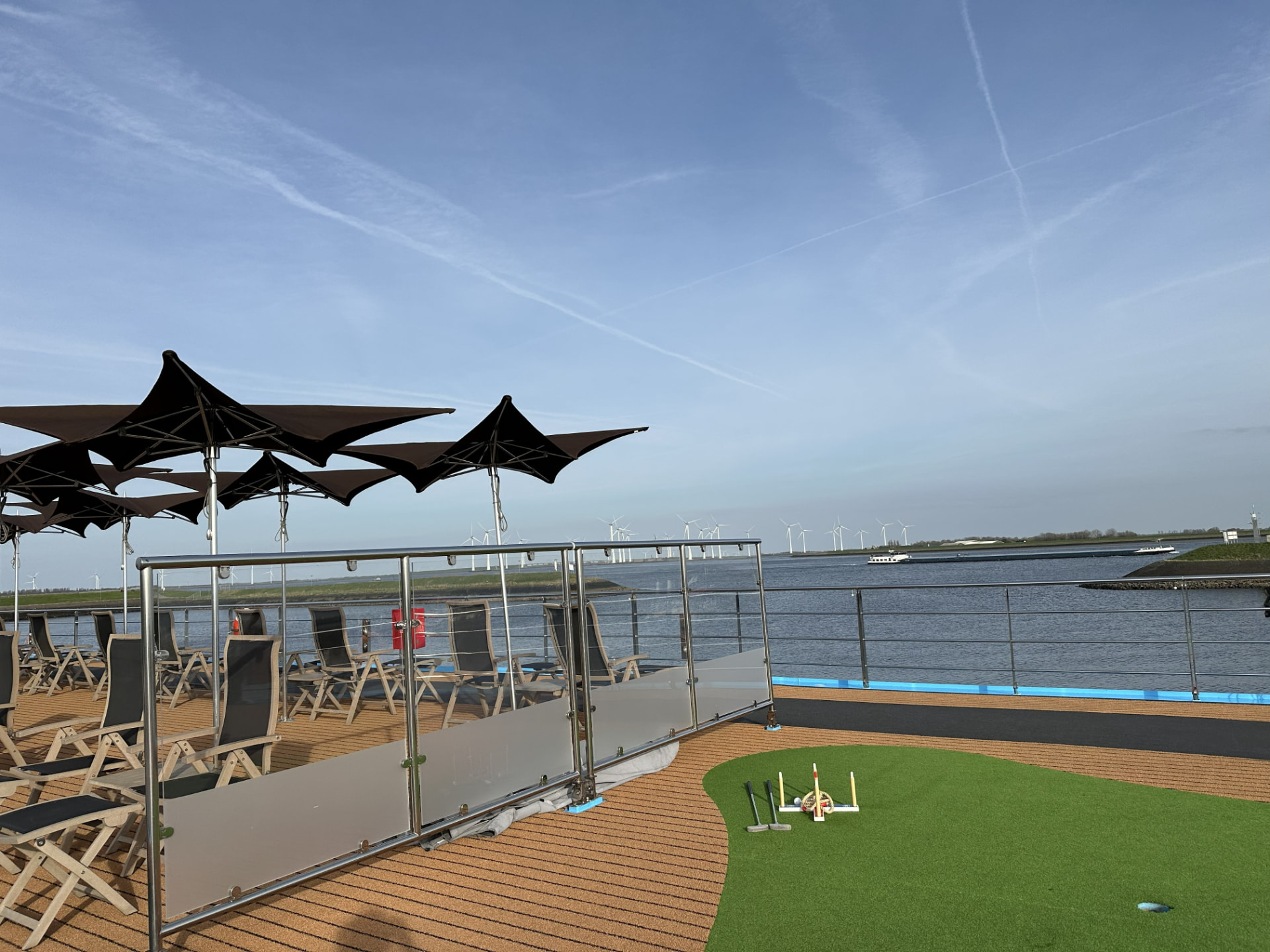 AmaSerena sun deck with lounge chairs, umbrellas, games, and Netherlands waterways in view
