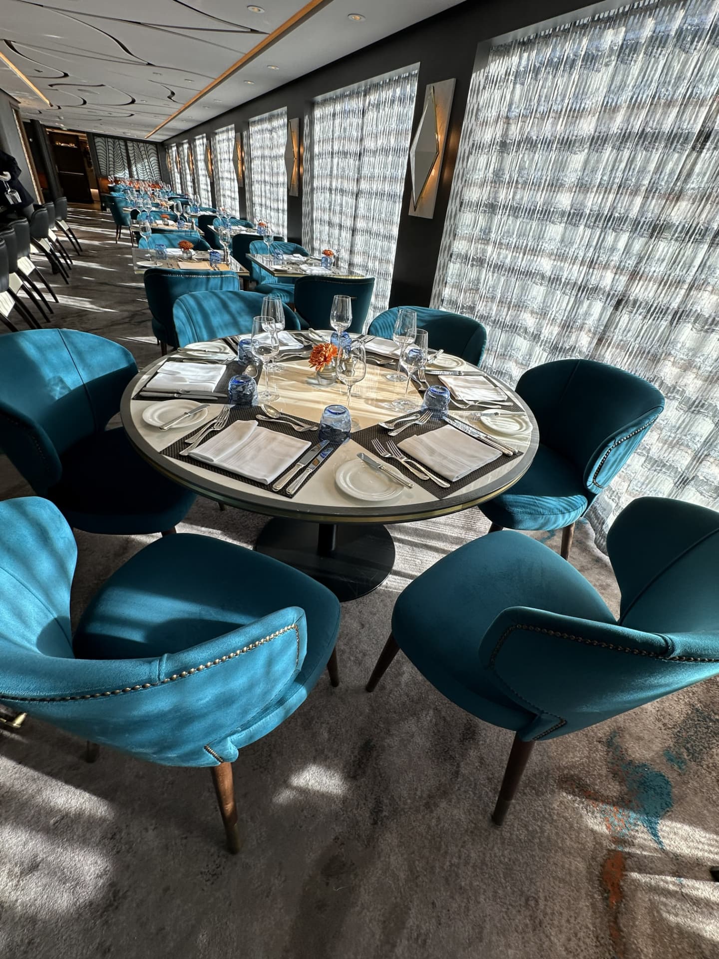 The dining room aboard Riverside Debussy, featuring the signature teal velvet chairs