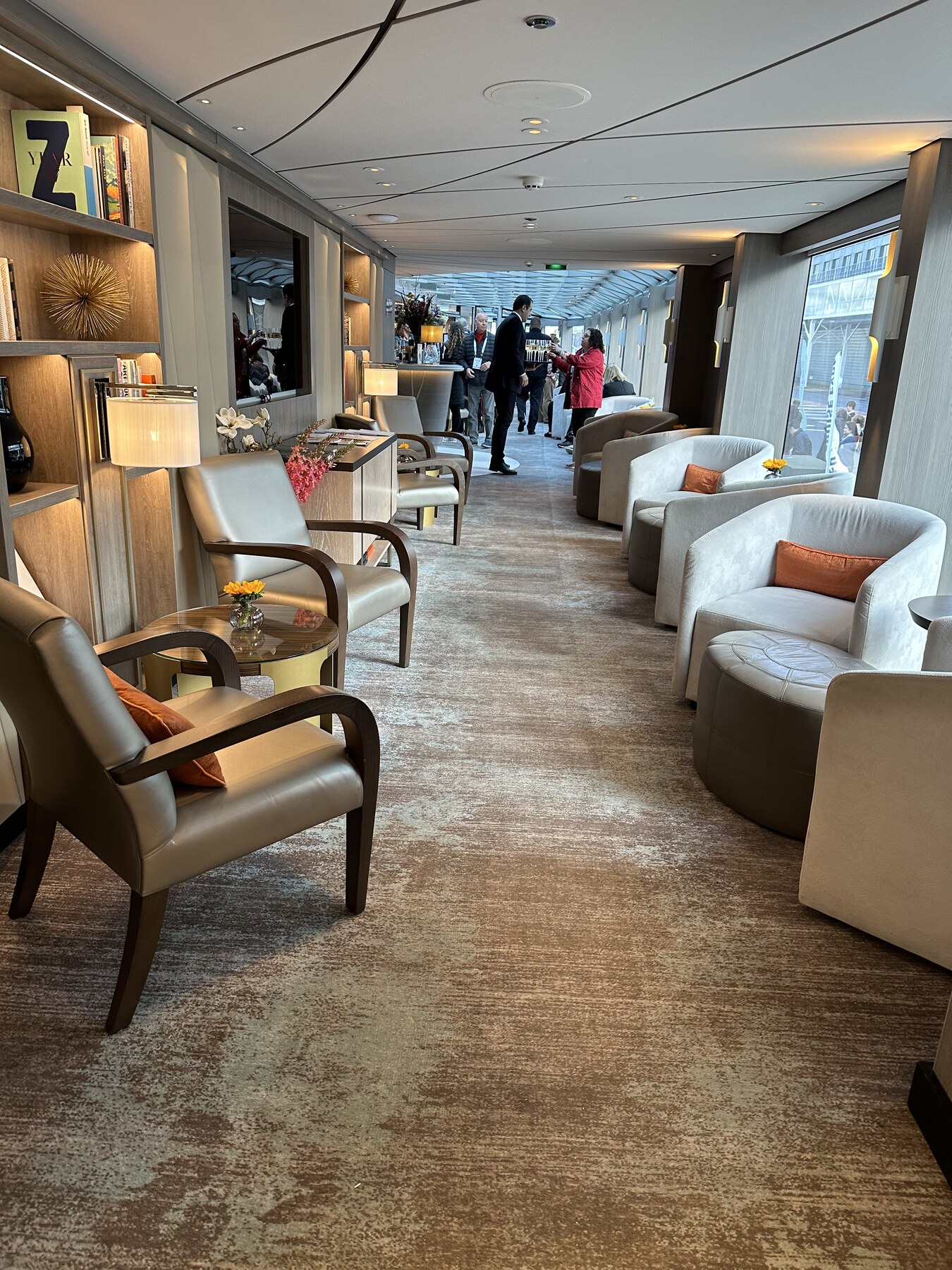 AmaViola lounge with armchairs and floor-to-ceiling windows on the AmaWaterways river cruise ship