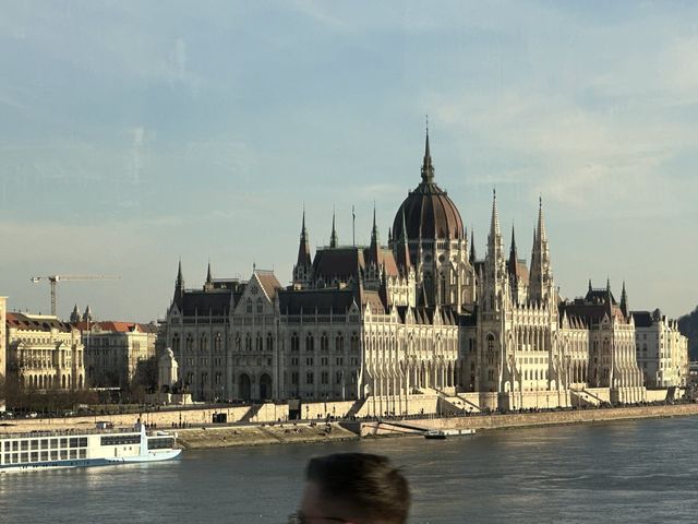 Hungarian Parliament Building on the Danube with a river cruise ship docked below