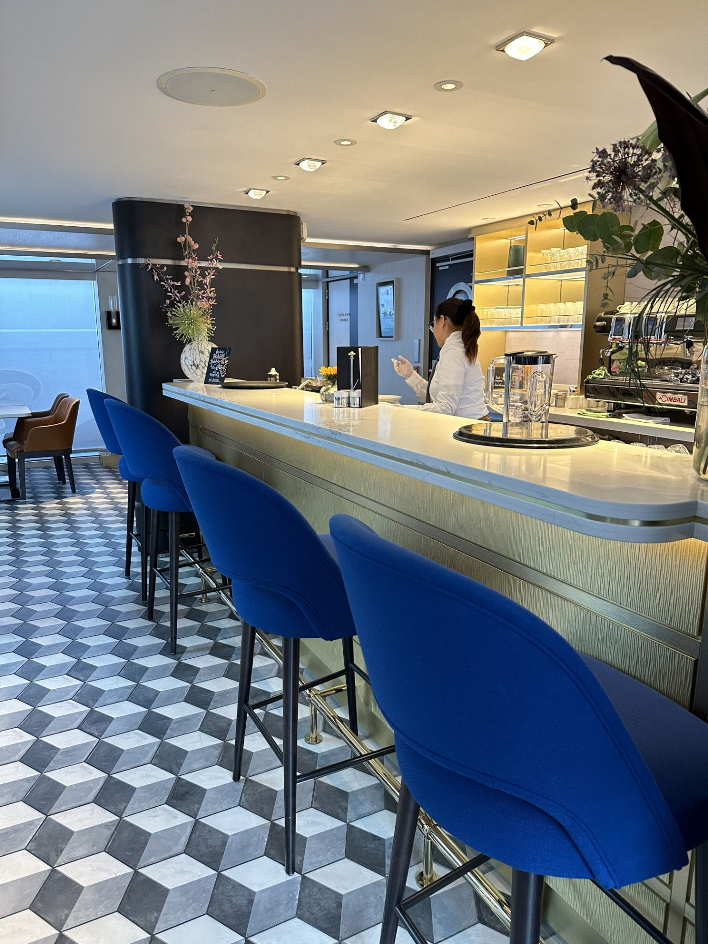 The bar and lounge with cobalt blue seating and geometric tile