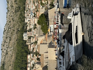 Boats moored in Dubrovnik's old harbor beneath the city walls