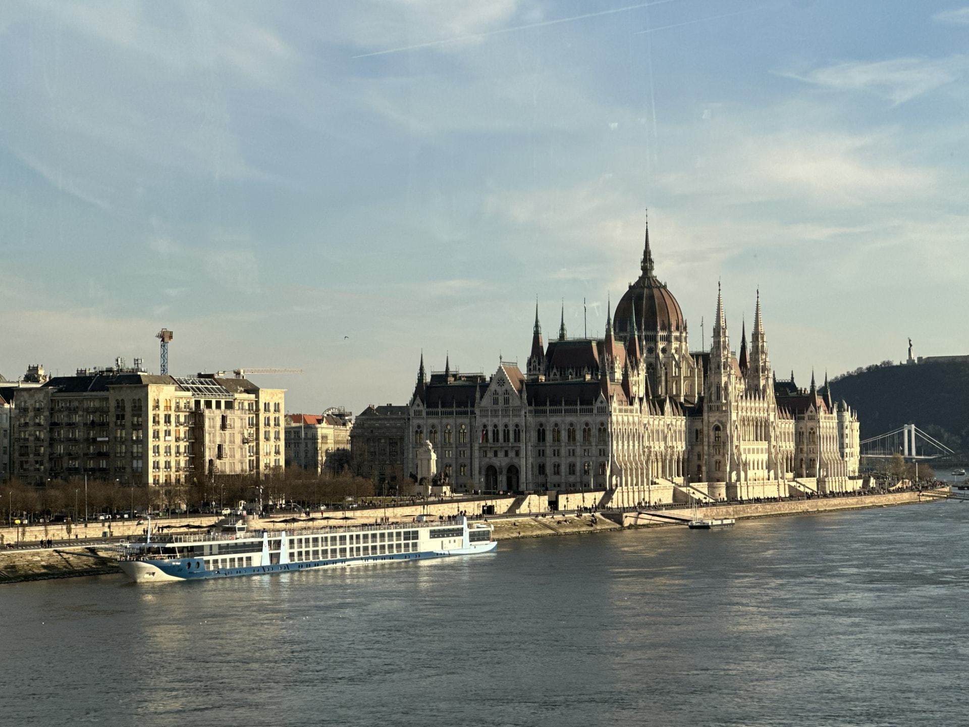 Hungarian Parliament Building in Budapest with a river cruise ship docked on the Danube