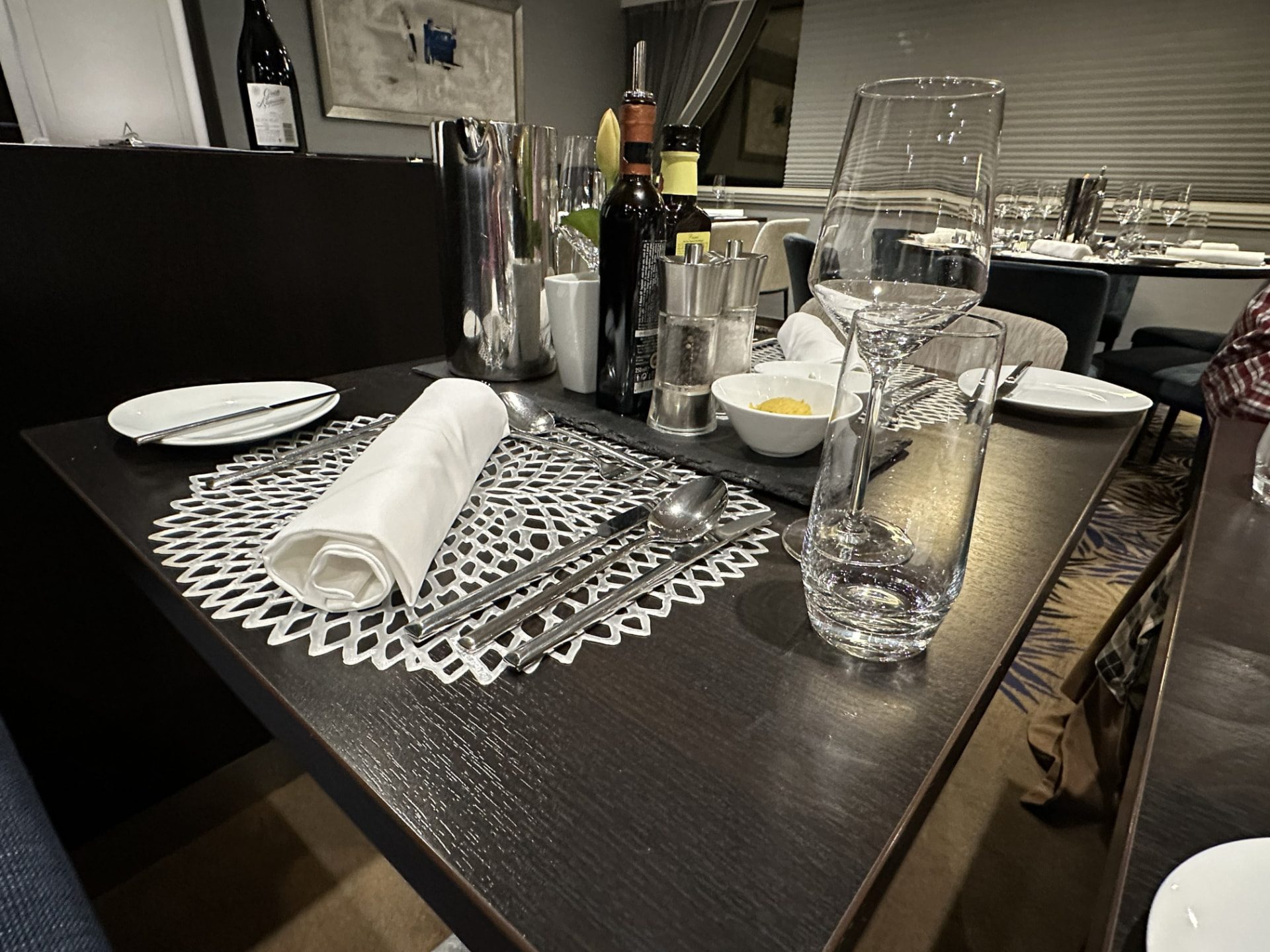 AmaSerena dining table set with glassware, linens, and silverware in the main restaurant