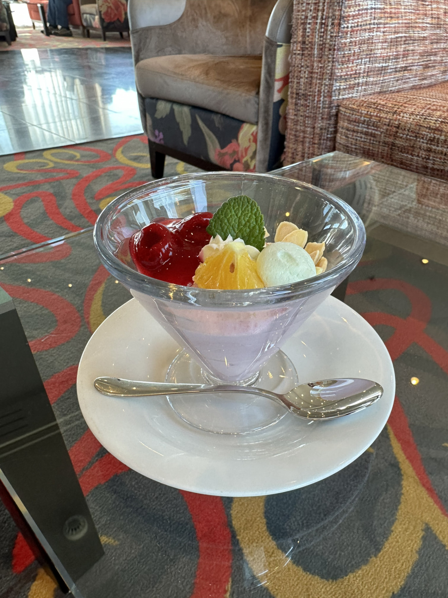 AmaSerena dessert served in a glass with fruit, mint, almonds, and a scoop of ice cream